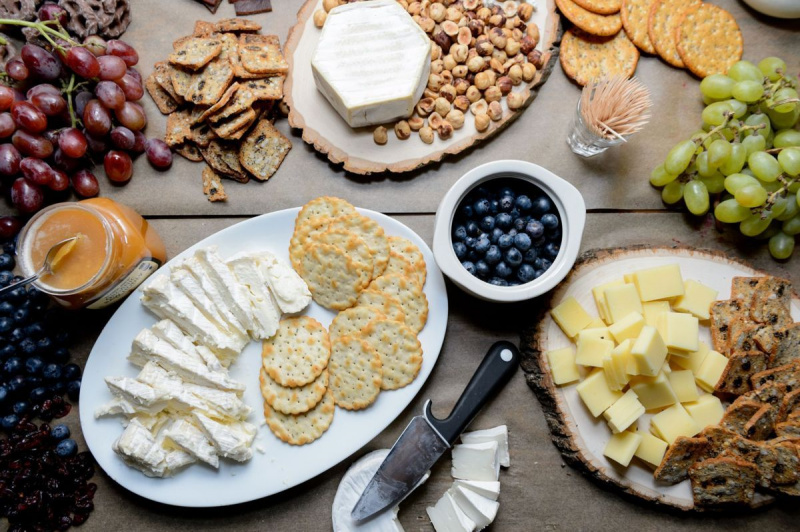 Stalas su sūriu ir vaisiais, išklotas vakarėliui